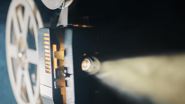 film projector on a black background with dramatic lighting and selective focus