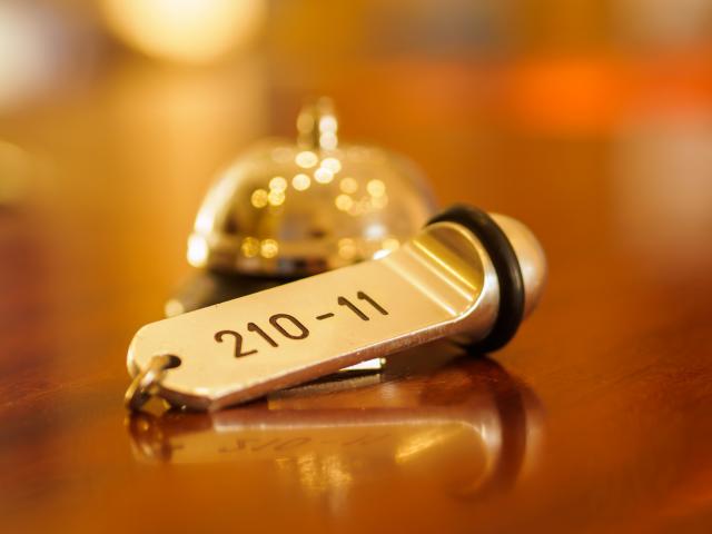 Reception - Hotel bell and key lying on the desk