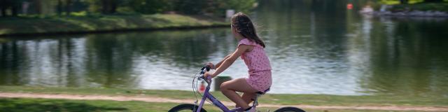 petite fille faisant du Vélo au bord du lac du Parc des Loisirs de Léry-Poses dans l'Eure en Normandie